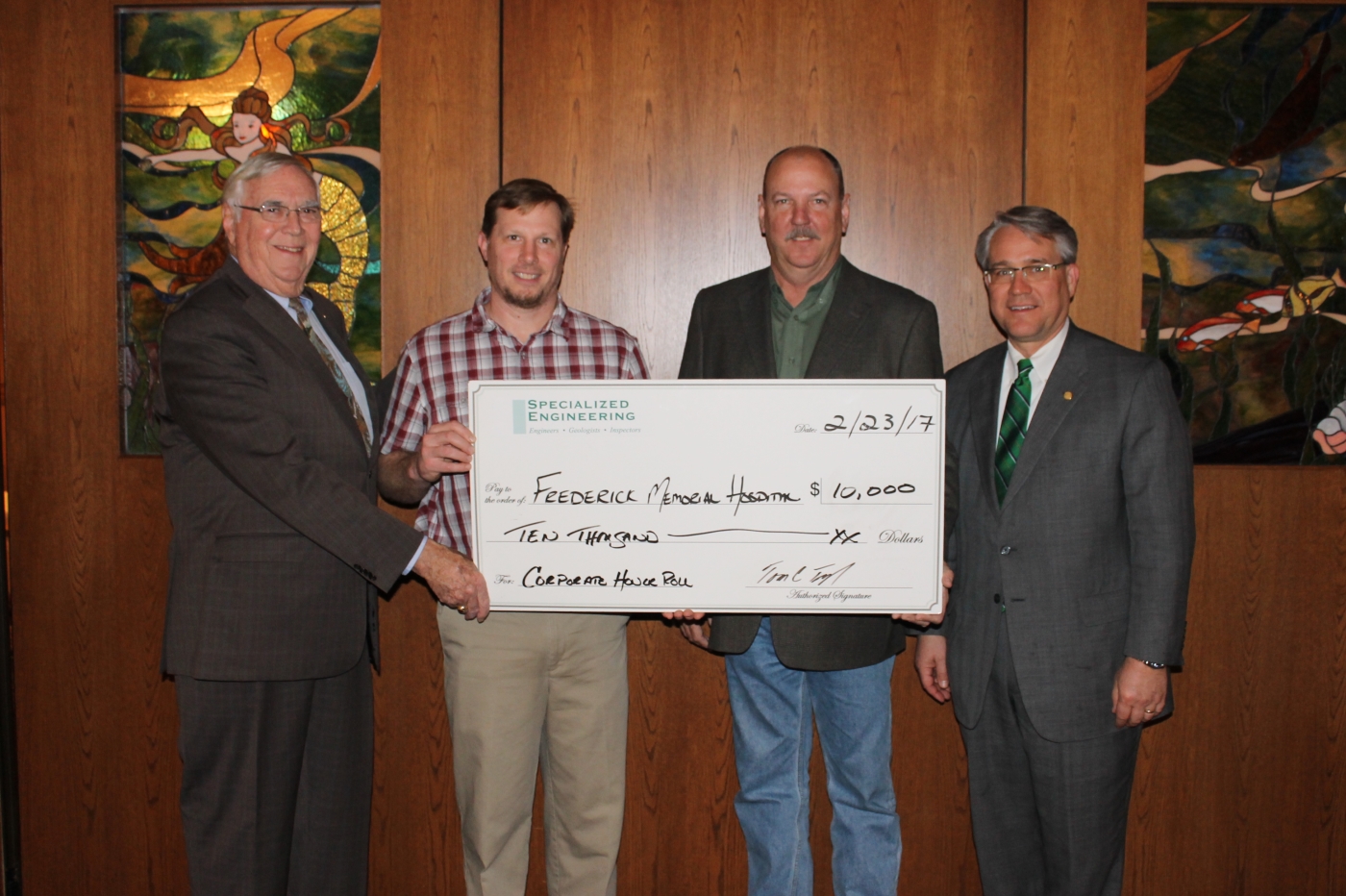 group holding a check